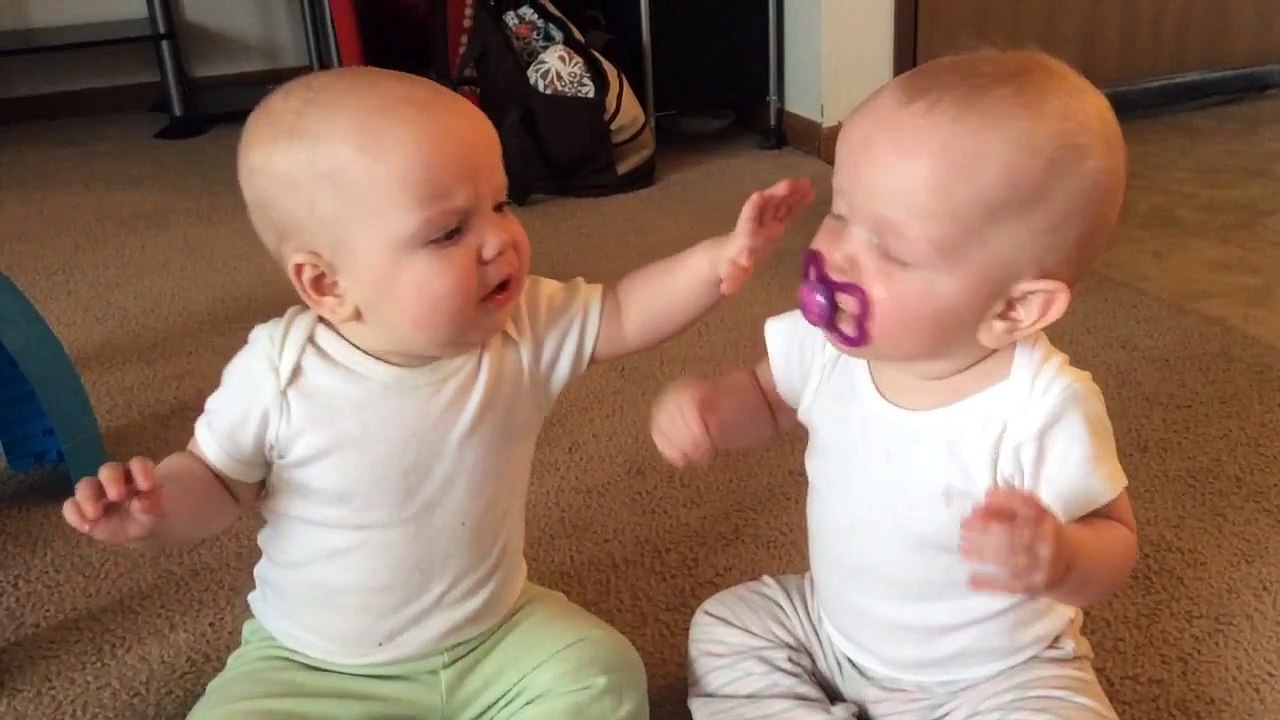 Twin baby girls fight over pacifier