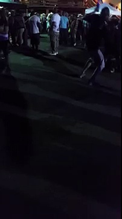 Guy throws a beer bottle into crowd.