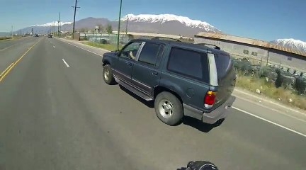 Motorcyclist Grabs Coffee Mug From Back Bumper Of Passing SUV
