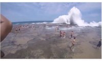 A Huge Wave takes out Swimmers