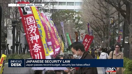 Japan passes record budget, security law takes effect