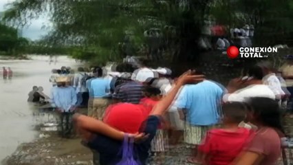 Gente cruzando en lancha el río San Antonio