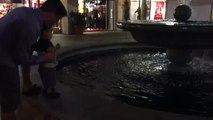Kiyo throwing coins into fountain