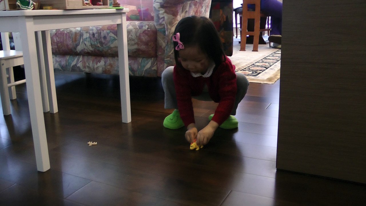 Girl Winding Her Dinosaur
