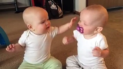 Twin baby girls fight over pacifier