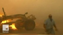 The horrifying moment a man narrowly escapes a raging wildfire