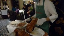 PEKING DUCK BEING CARVED BY AN EXPERT