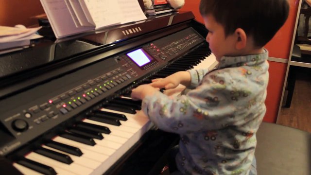 3 years old boy playing piano