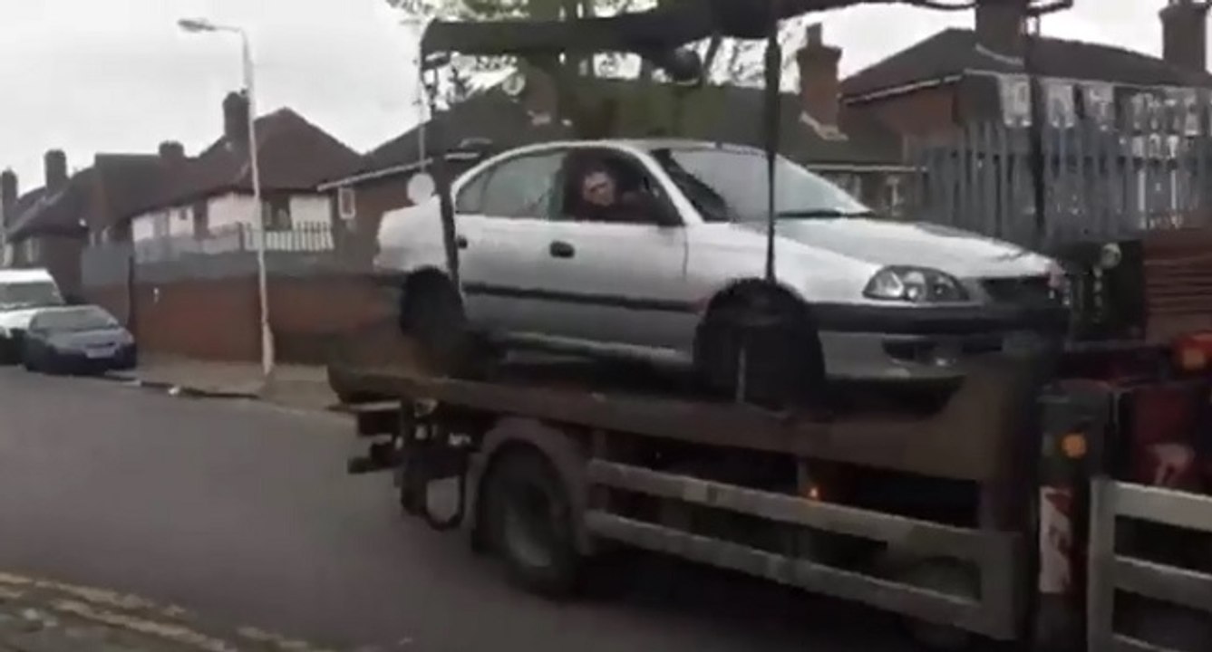 Un idiot veut descendre sa voiture du camion de la fourrière