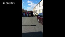 Ferrari crumples after hitting wall in front of house in Burnley, UK