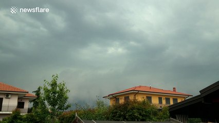 Storm passes over town on the slopes of Mount Etna