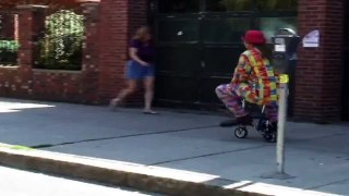 funny clown on bike gets hit by car