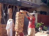 A worker is going to take 52 bricks back parathas second floor at a time Reporting by ( PCCNN) Chaudhry Ilyas Sikandar