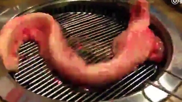 Creepy 'zombie' eel wriggles desperately on barbecue after being 'skinned alive'
