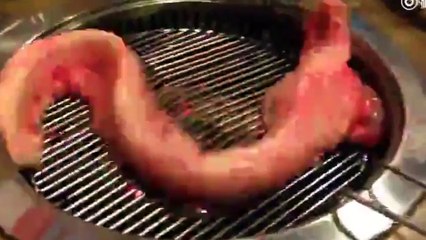 Creepy 'zombie' eel wriggles desperately on barbecue after being 'skinned alive'