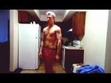 Guy taking his shirt off in slow motion while wear
