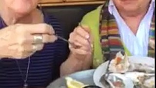 Friends in restaurants eating oysters