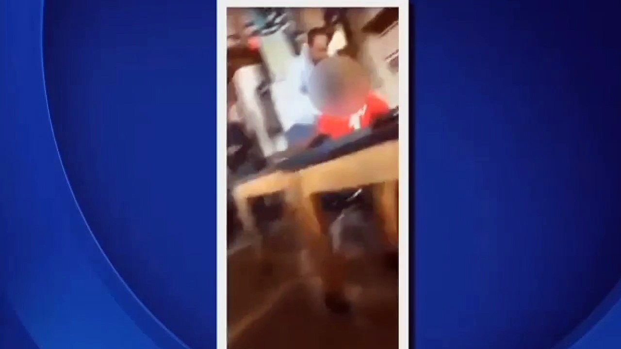 a teacher's aide pushing a student onto a desk hen holding him by his neck (MILWAUKEE)