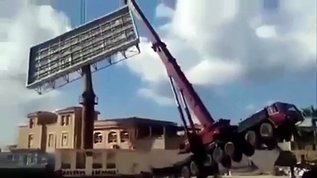 Disgruntled Co Worker Uses Dozer To Flip A Crane As It Is Installing A Billboard