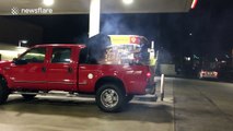 Man plays Purple Rain drum riff in the back of a truck at a petrol station
