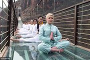 180 meters above the ground! Girls practise yoga on glass-bottom bridge in Henan, China.
