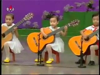 North Korea children playing the guitar. Creepy as hell.