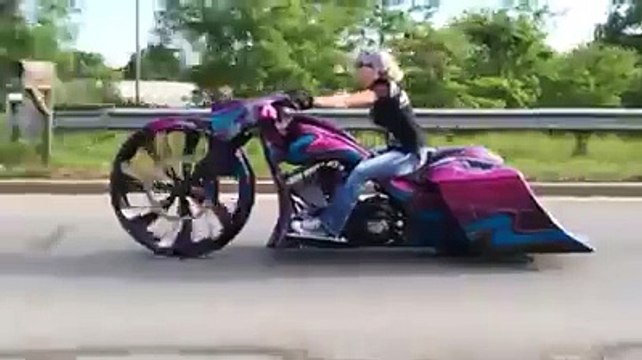 Chick riding a Crazy 32 inch big wheel bagger