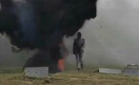 Russian Solider Testing A Bomb Suit By Walking Through A Field Of Explosives