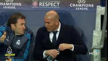 Zidane talks to staff member about his ripped pant, but doesn’t care about it and walks back to the sideline.