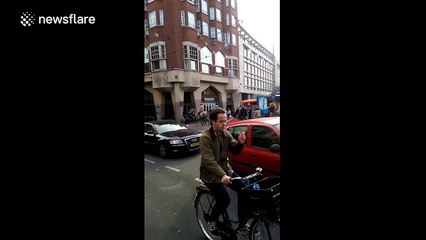 Half-naked horserider drags landsurfer on streets of Amsterdam