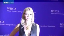 Kelly Rohrbach giggles as she poses on the red carpet