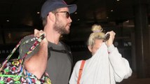 Liam Hemsworth and Miley Cyrus Hold Hands as They Land in LA