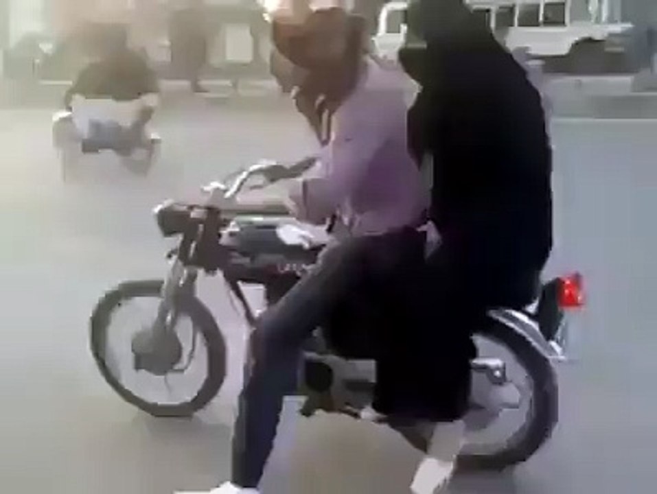 Boy wheeling on Bike with his GF