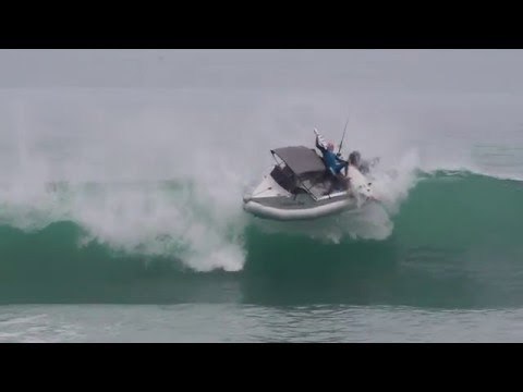 Surfers Caught Off Guard After Large Wave Flips Over Boat