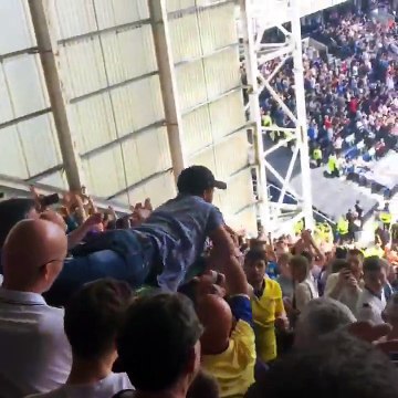 Leeds fan crowd surfing from the top of the away end to the bottom at Preston
