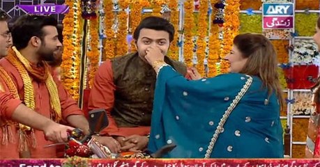 Relatives of the bride grab the groom's nose in fun