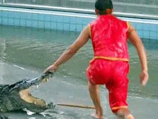 Man playing with crocodile