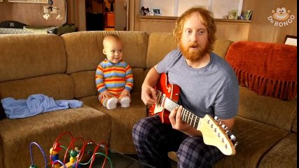Baby playing guitar like a real rock star