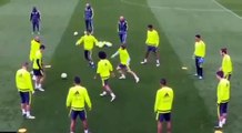 Luka Modric lightly pushes Cristiano Ronaldo over, in training