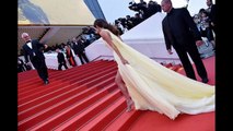 Amal Clooney struggles with her thigh-split gown with George Clooney on the Cannes red carpet