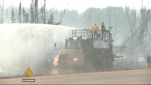 Canada evacuates oil workers as wildfire spreads