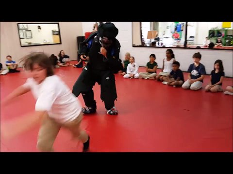 Children doing self defense on a padded attacker