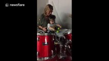 One-year-old girl plays the drums for the first time