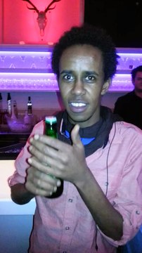 guy opens a beer with his teeths