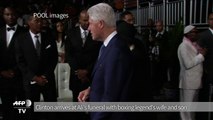 Bill Clinton arrives at Ali's funeral with Ali's wife and son