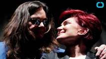 Sharon & Ozzy Osbourne Hug At Press Event