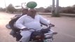 Man Riding bike having watermelon on his head