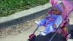 Baby doll sitting round trip walk to slide down the slide at a playground swing