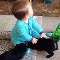 Cute Baby Playing With Two Little Beautiful Black Rabbits