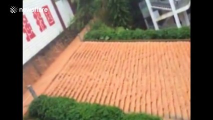 School 'wall' brought down by floodwater